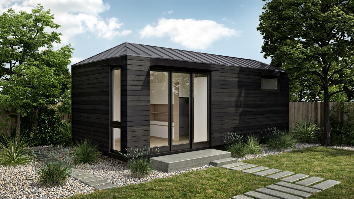 A black ADU House in a backyard, with a glass window and door