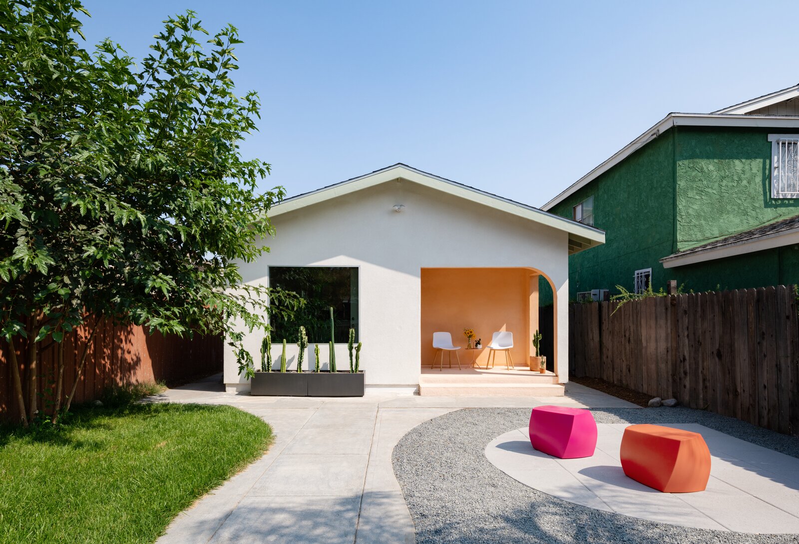 A white ADU house in a backyard